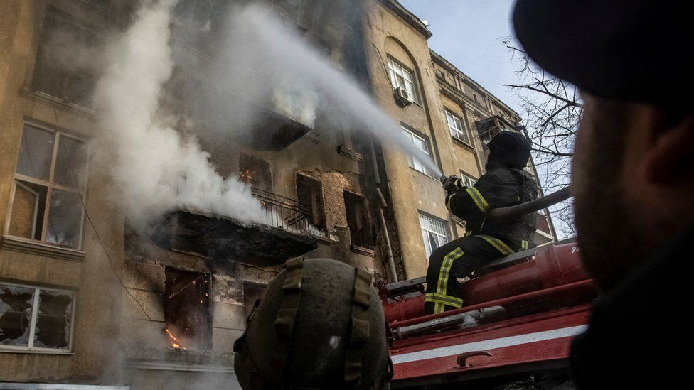 Firefighters put out a blaze at a residential building hit by a Russian military strike in Bakhmut