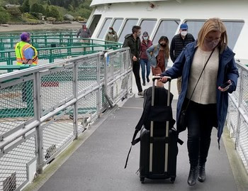 Photo of people walking off a ferry