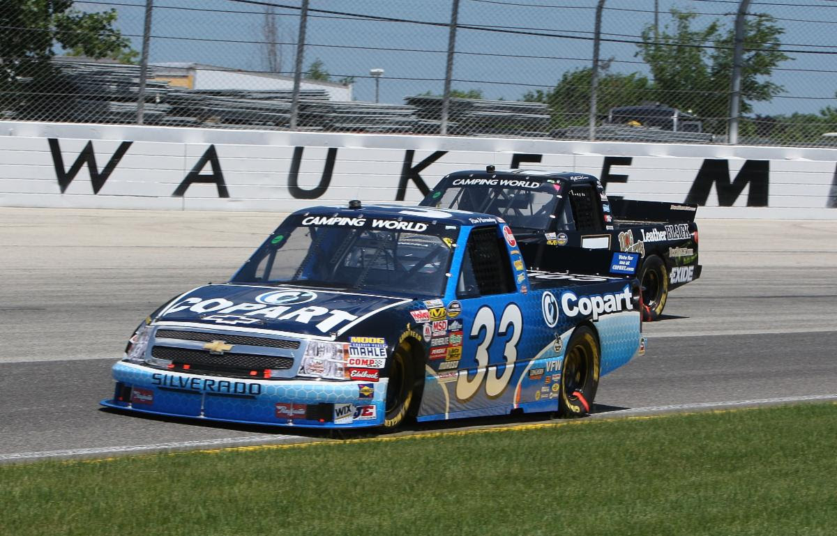 ATLANTA, GA - JULY 09: Kevin Harvick (#4 Stewart Haas Racing Hunt Brothers  Pizza Ford) and Ross Chastain (#1 Trackhouse Racing Worldwide Express  Chevrolet) race side by side the NASCAR Cup Series