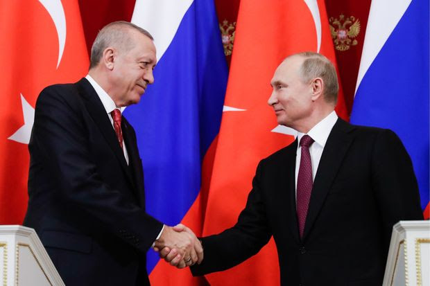 Turkey's President Recep Tayyip Erdogan, left, and President Vladimir Putin of Russia appear at a joint news conference in Moscow on Wednesday.