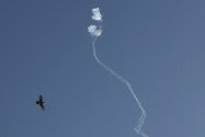 An Israeli Iron Dome defense system missile intercepts a rocket fired from Gaza .