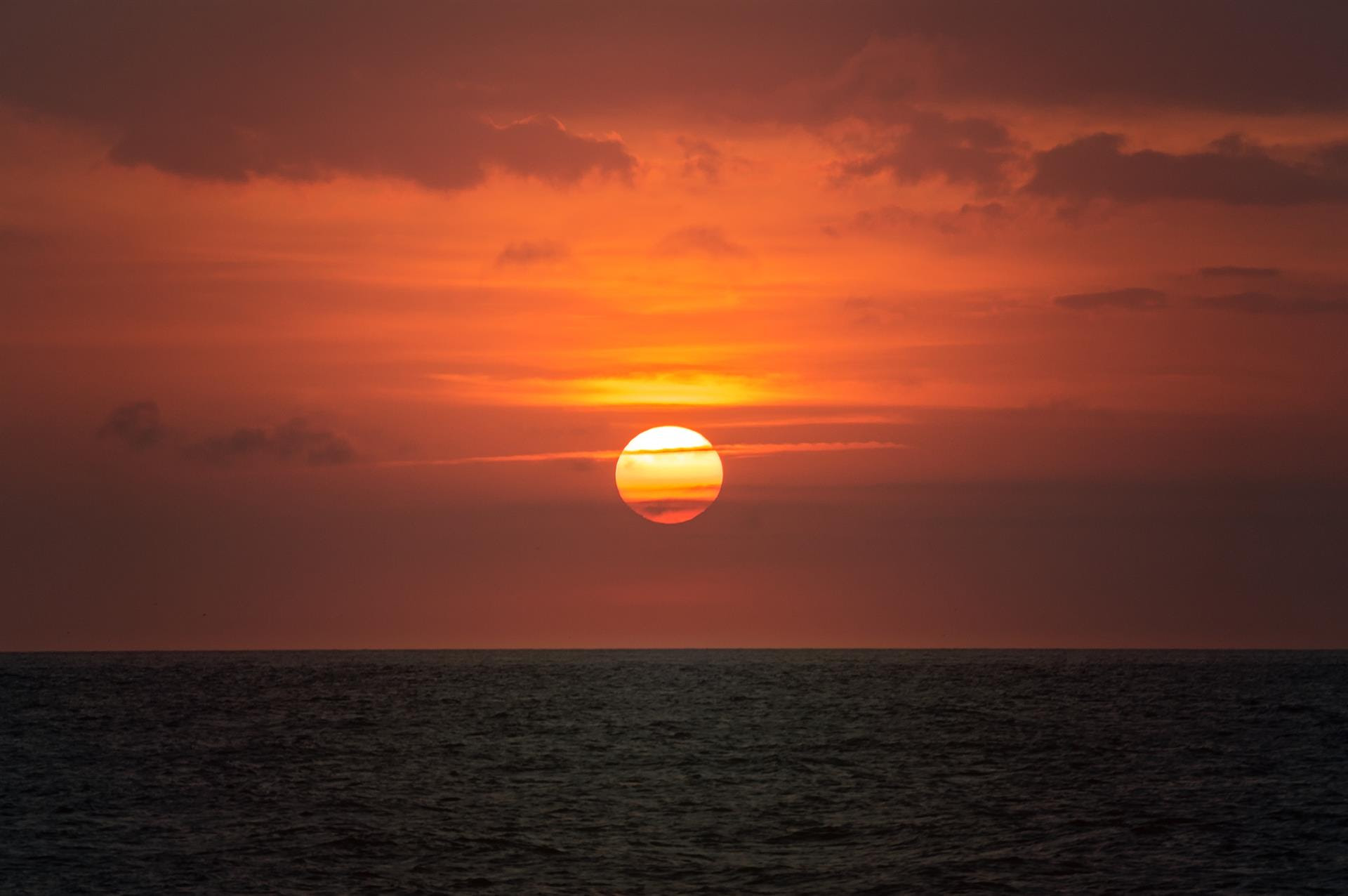 The sun sets over a vast ocean The sun sets over a vast ocean