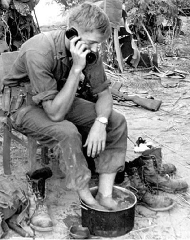 vintage wwii soldier soaking feet in bucket