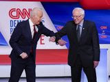 Former Vice President Joe Biden, left, and Sen. Bernie Sanders, I-Vt., right, greet one another before they participate in a Democratic presidential primary debate at CNN Studios in Washington, Sunday, March 15, 2020. (AP Photo/Evan Vucci)