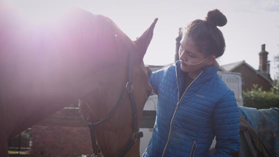 A young woman with a horse