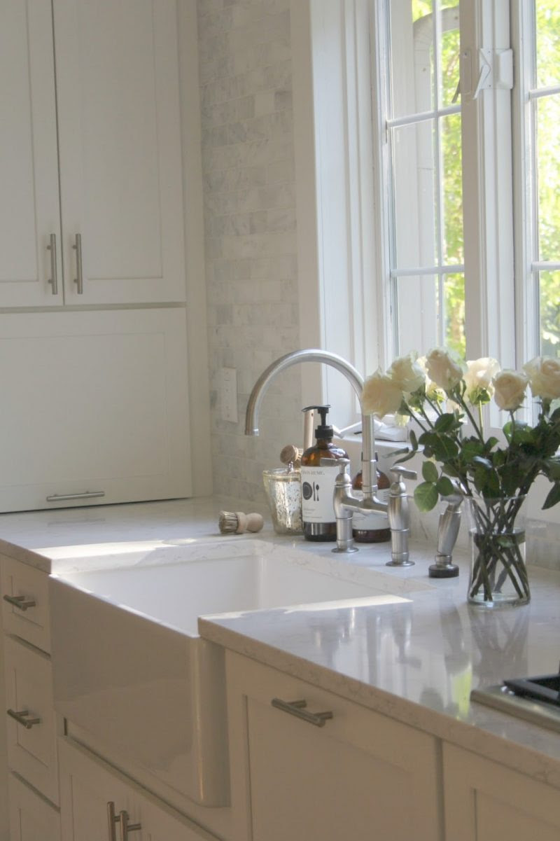 White Shaker style kitchen with apron front farm sink by Hello Lovely Studio