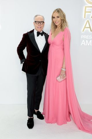 Image may contain Suit Clothing Formal Wear Dress Tuxedo Accessories Tie Fashion Adult Person and Glasses