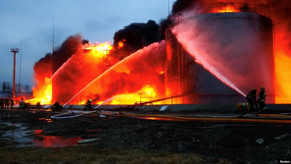 First responders work at a fuel-storage facility hit by cruise missiles in Lviv in western Ukraine on March 27.