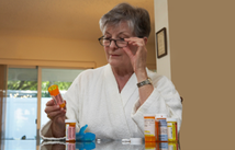 Patient looking at a pill bottle