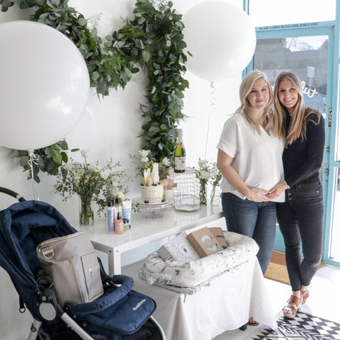 two women standing at a baby shower