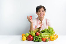 Asian woman with fruits and vegetables