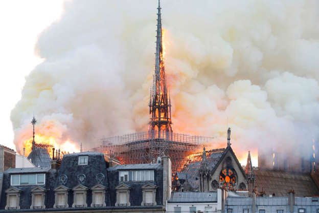 Slide 28 of 31: Smoke and flames rise during a fire at the landmark Notre-Dame Cathedral in central Paris on April 15, 2019, potentially involving renovation works being carried out at the site, the fire service said. (Photo by FRANCOIS GUILLOT / AFP) (Photo credit should read FRANCOIS GUILLOT/AFP/Getty Images)