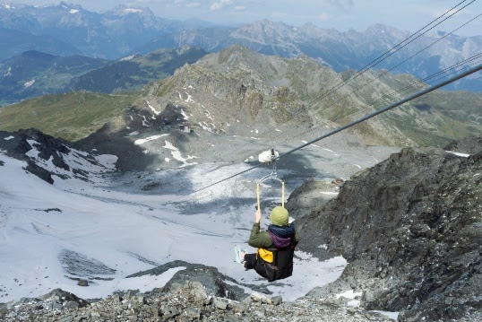 A person riding skis down a snow covered mountain

Description automatically generated