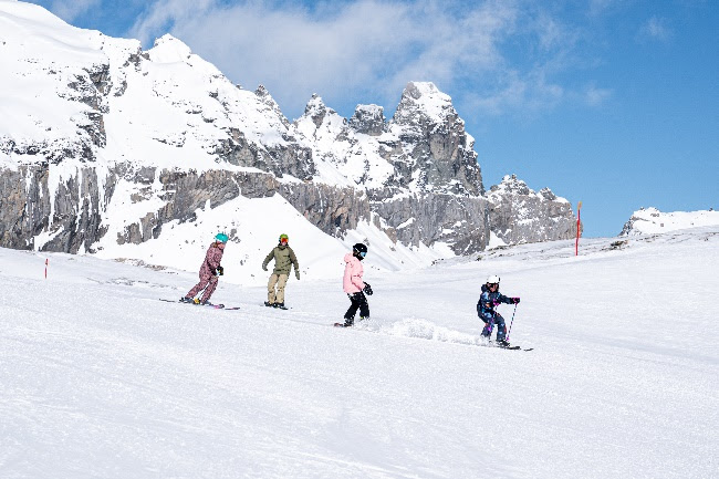 A group of people skiing on the snowDescription automatically generated with medium confidence