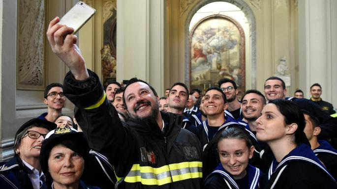 Matteo Salvini takes a selfie with firefighters in the Basilica of San Giovanni Laterano in Rome