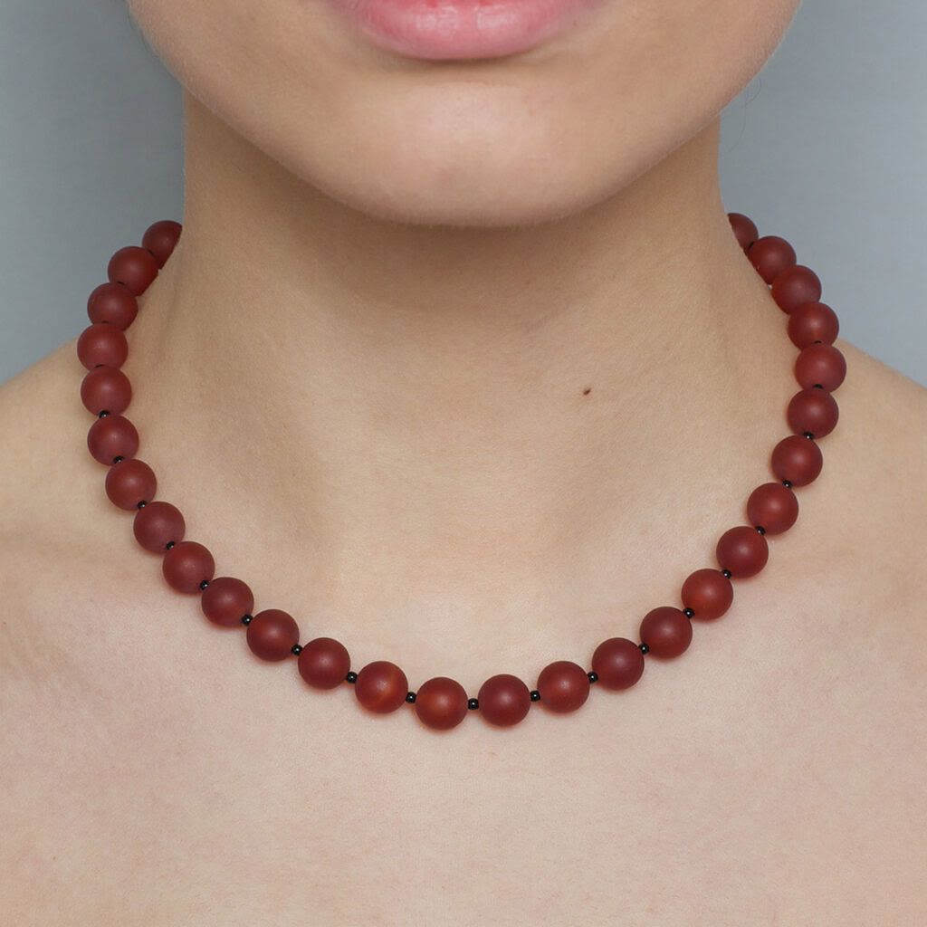 Model wears frosted carnelian and onyx necklace at designyard contemporary jewellery dublin ireland 