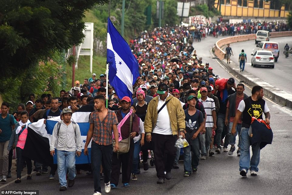 Migrants with the Honduran flag take part in a caravan towards
