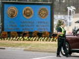 A police officer stands at a gate to Fort Meade directing a vehicle to turn away after a vehicle rammed a gate to the National Security Agency, Monday, March 30, 2015 in Fort Meade, Md. One person was killed in a firefight that erupted Monday after a car with two people tried to ram a gate at the Fort Meade, Md., military base near a gate to the National Security Agency, according to preliminary reports cited by two U.S. officials. (AP Photo/Andrew Harnik)