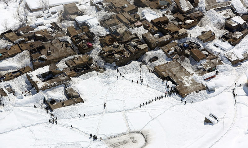 Survivors wait to receive food donations near the site of an avalanche in the Paryan district of Panjshir province, north of Kabul, Afghanistan, Friday, Feb 27, 2015. — AP