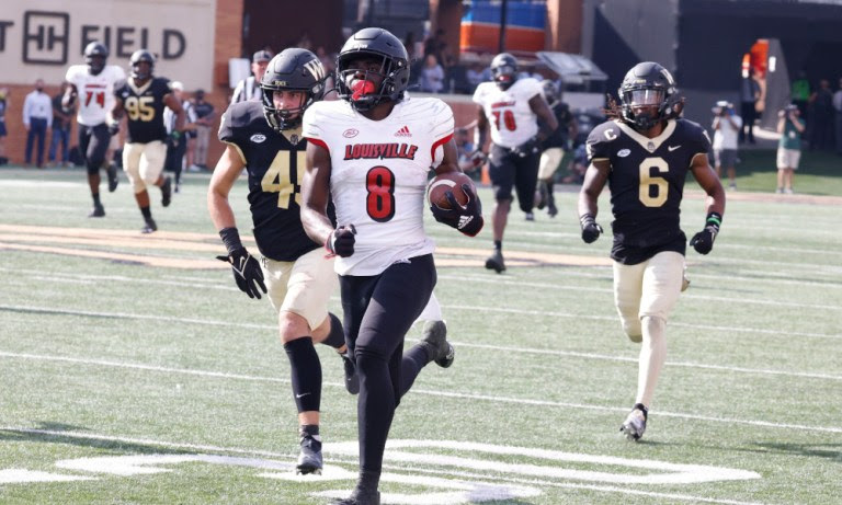 Tyler Harrell (#8) runs by Wake Forest's defense in 2021 for a Louisville touchdown's defense in 2021 for a Louisville touchdown