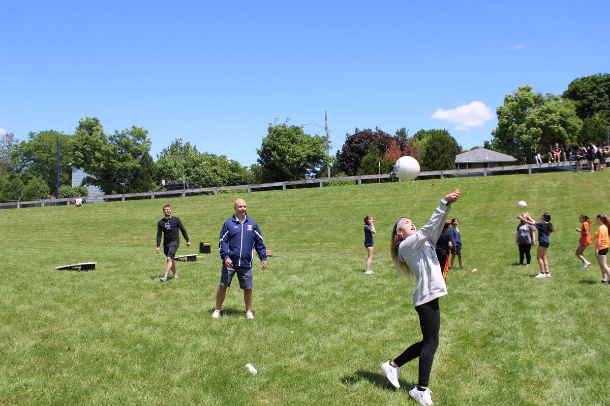 students play field day games outdoors on grass