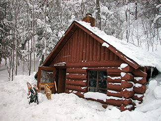 A wintry scene is shown from the Mirror Lake Cabin.