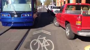 Streetcar, bikes and parked cars