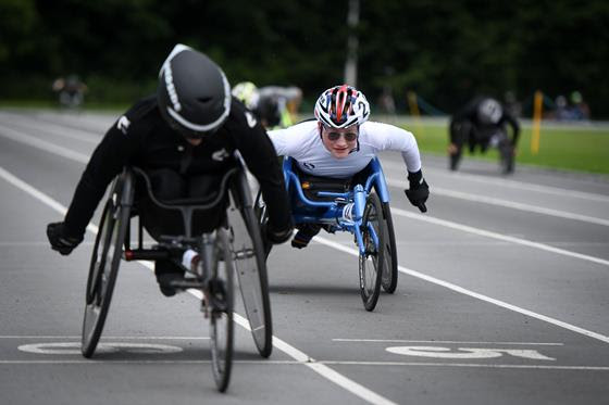 Wheelchair athletes on a track racing