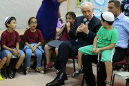 Consistent morals, even in the face of rocket fire: then-President Shimon Peres visits a Sderot summer day camp. (archive)