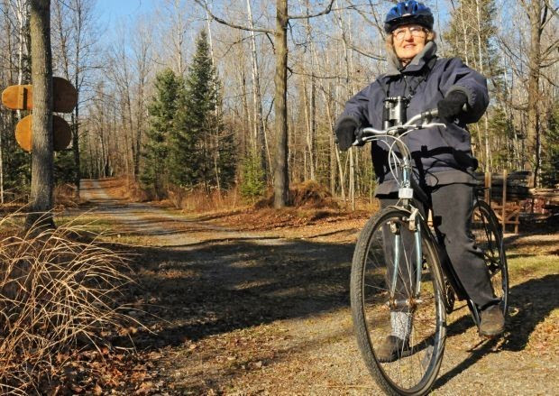 Kay Kavanaugh, who often birds by bike when conditions allow, is shown on her bike. 