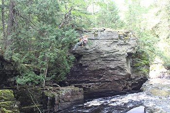 Park ranger on rescue rope over river