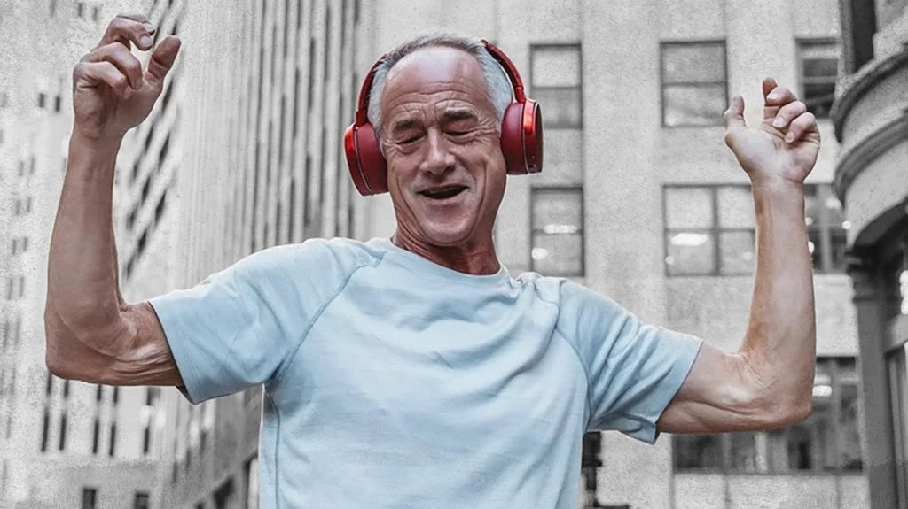 older man listening to music on his headphones