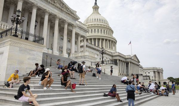 Protesters advocating for reinstating the now-expired nationwide eviction moratorium sit outside of Capitol Hill in Washington on Tuesday, Aug. 3, 2021. (AP Photo/Amanda Andrade-Rhoades)