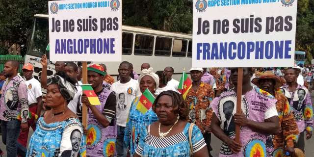 Demonstrators carry banners as they take part in a march voicing their opposition to independence or more autonomy for the Anglophone regions, in Douala