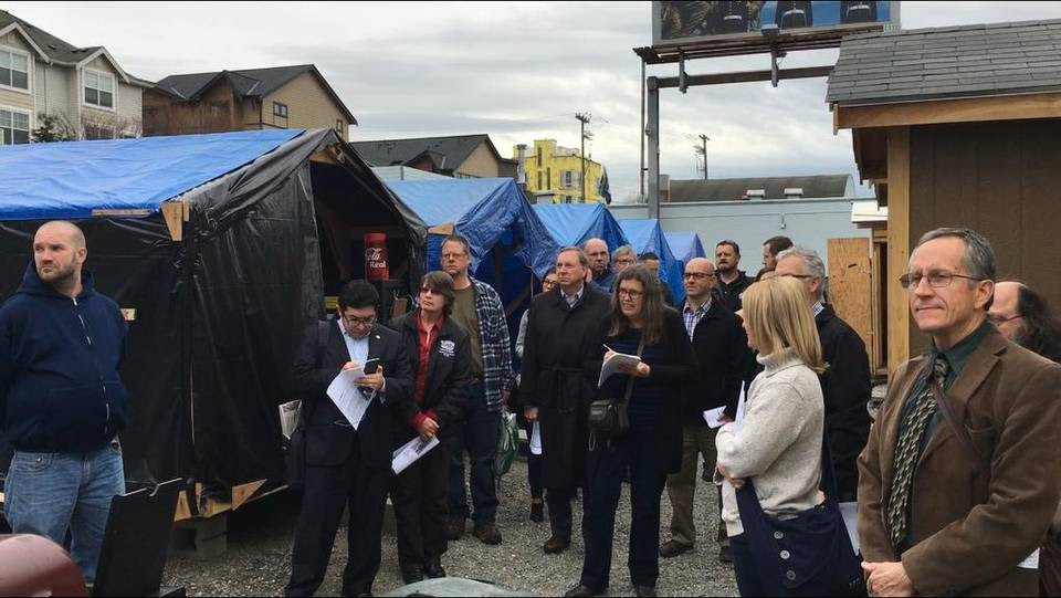 A delegation of Sacramento Council members, community leaders and city officials visits a city-sanctioned living area for homeless residents in Seattle. Friday, Feb. 28, 2016.