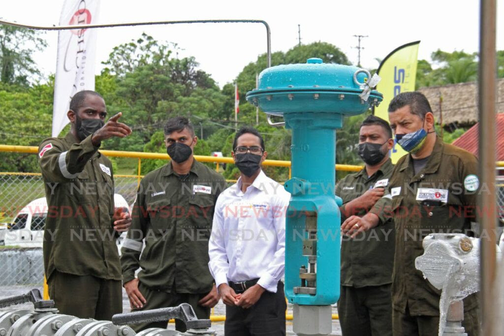 Christopher George, left, Touchstone Exploration general manager, operations, along with senior workers and Ramps Logistics Ltd general manager Javed Razack at the unveiling of new equipment, Forest Reserve, Fyzabad on Friday. - MARVIN HAMILTON