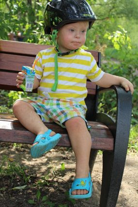 special needs child sitting on bench