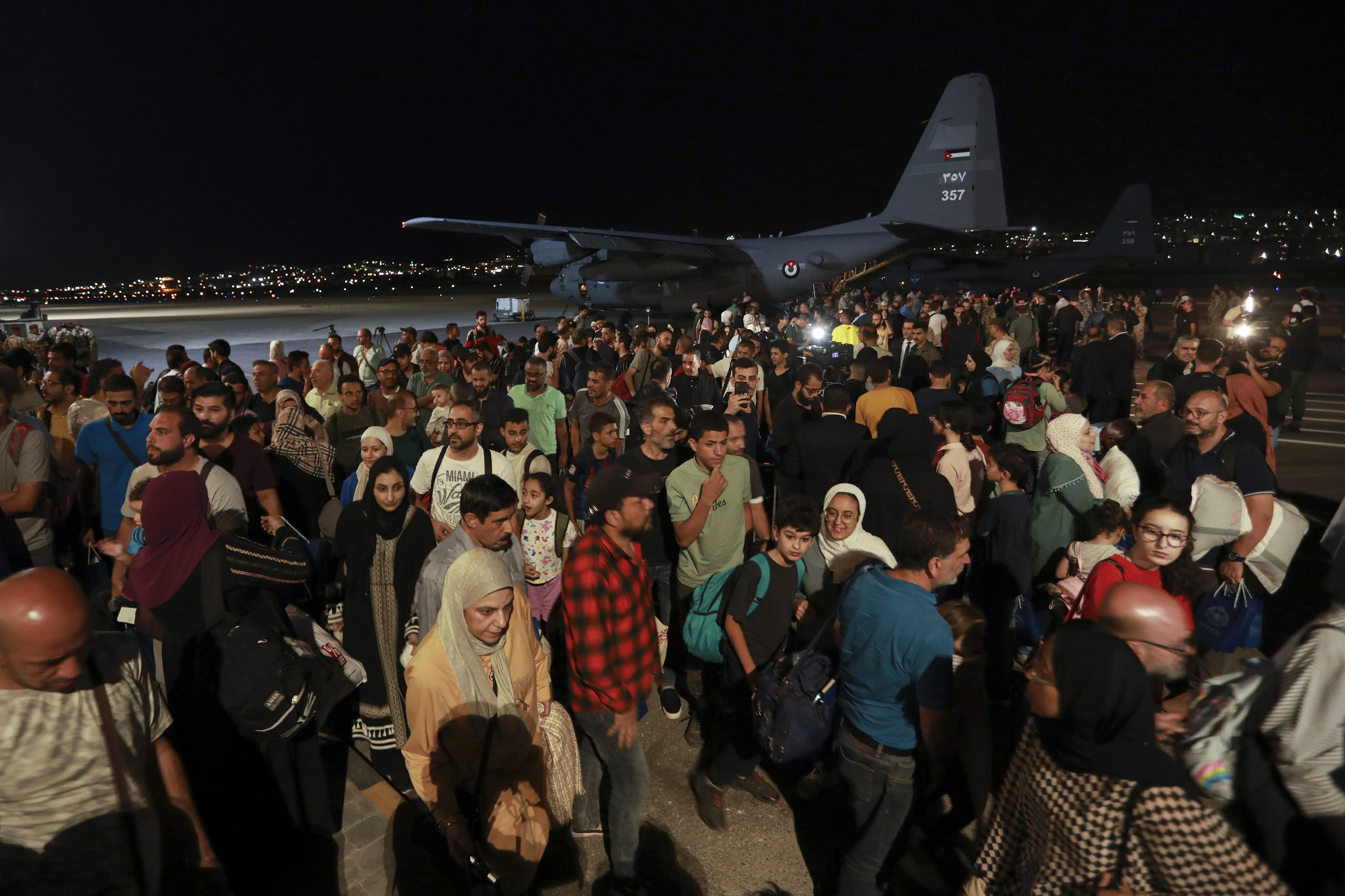 This image shows evacuees from Sudan arriving at a military airport in Jordan