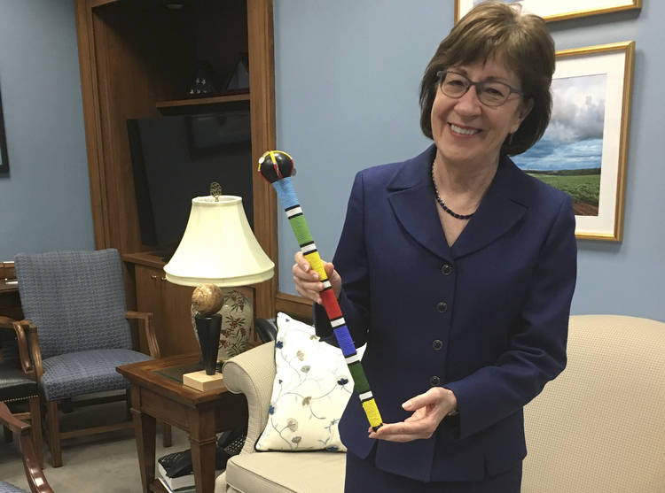 Sen. Susan Collins (R-Maine) holds a colorfully beaded "talking stick" in her office on Capitol Hill, which she used during contentious negotiations between Senate moderates to end the shutdown. (Alan Fram/AP)
