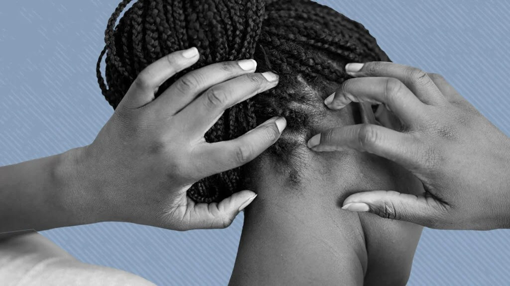 A Black woman with braided hair touching her scalp, isolated on a light blue background.