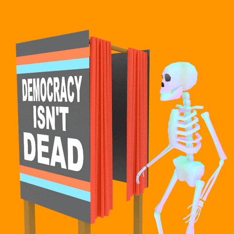 Image of a skeleton going in the voting booth with the words "democracy isn't dead" written on the booth
