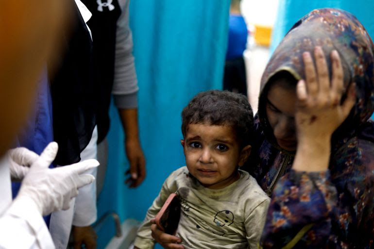 A Palestinian child wounded in Israeli strikes amid the ongoing conflict between Israel and Palestinian group Hamas waits to receive treatment at Nasser hospital in Khan Younis