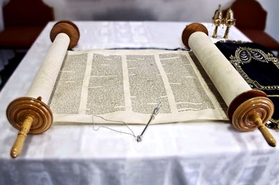 Open Torah scroll and silver
yad (Torah pointer)