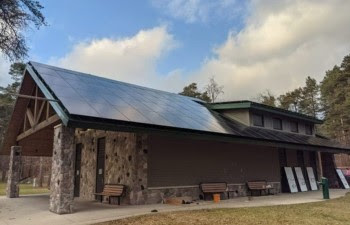 A park building with solar panels on the roof.