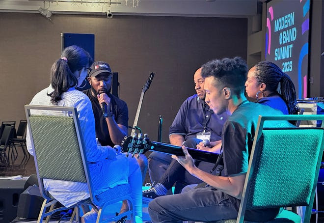 Toki Wright sings while gathered on stage with other music educators from the hip-hop genre during a roundtable discussion Thursday at 11th annual Modern Band Summit at Colorado State University's Lory Student Center Grand Ballroom in Fort Collins.