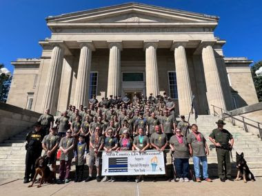 North Country Torch Run participants standing on steps of public building