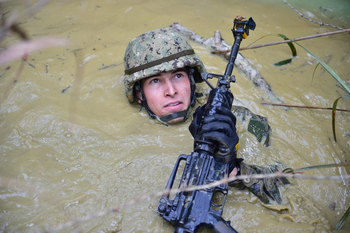 Sometimes working with allies means getting down and dirty. Here a Seabee gets neck deep in Japan.