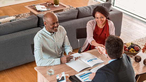 Couple Shaking Hands with Banker