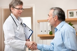 The figure above is a photograph of a health care provider meeting with a patient.