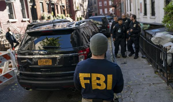 A federal agent stands in front of property connected to Russian oligarch Oleg Deripaska as members of the New York Police Department patrol the area, Tuesday, Oct. 19, 2021, in New York. More than half of Republican voters believe the FBI is acting as President Biden&#39;s personal secret state police, according to a poll released Tuesday. (AP Photo/John Minchillo)